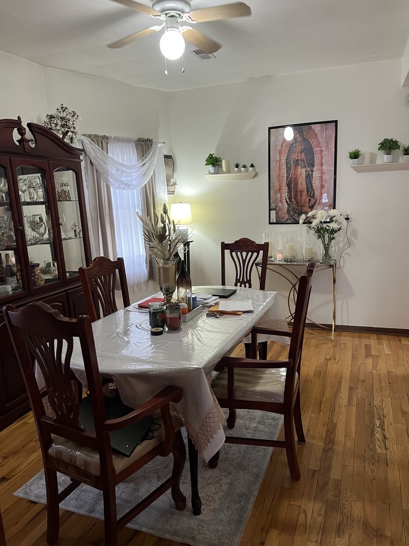 3331 West 64th Street Chicago, IL 60629 - Photo 4 of 15 a view of a dining room with furniture and wooden floor