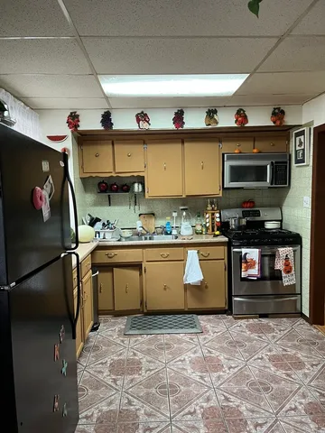 a kitchen with stainless steel appliances granite countertop a stove and a sink