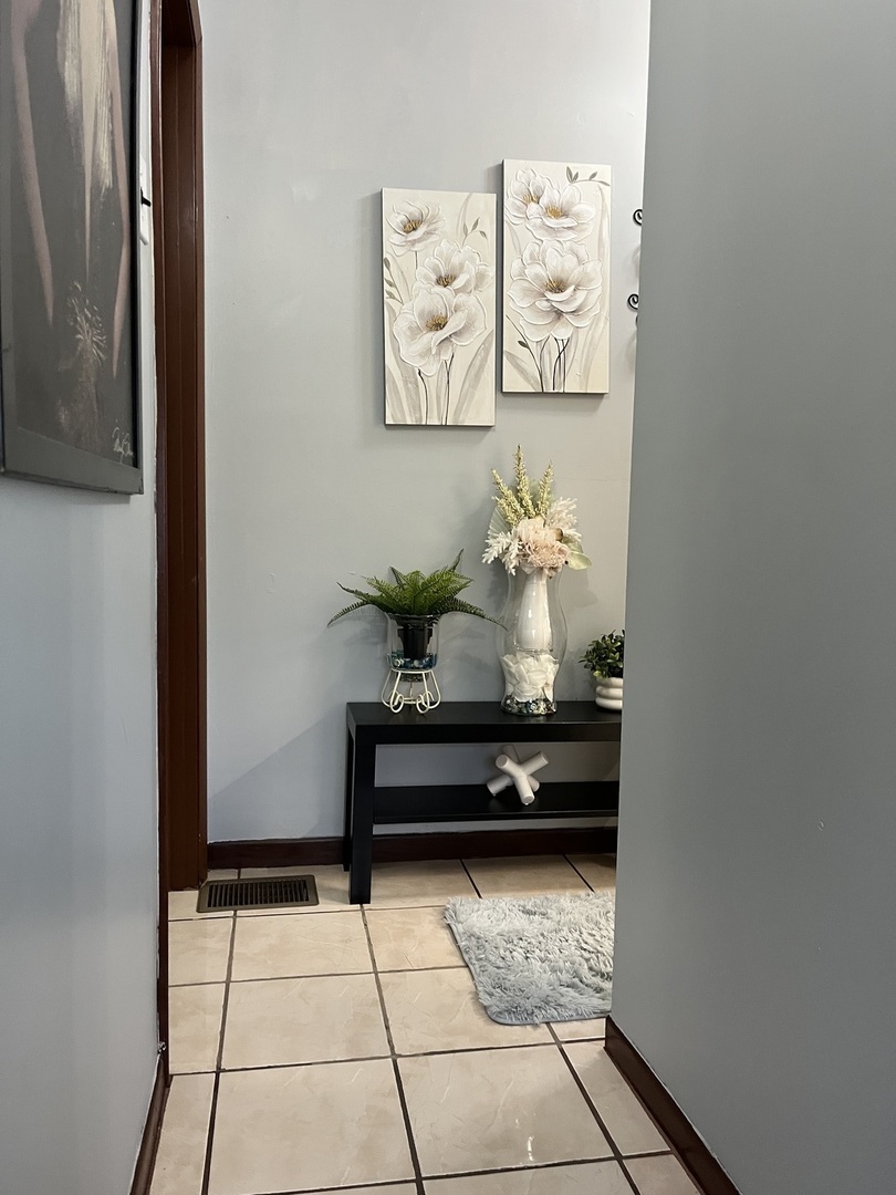 3331 West 64th Street Chicago, IL 60629 - Photo 10 of 15 a bath room with a table and paintings on the wall