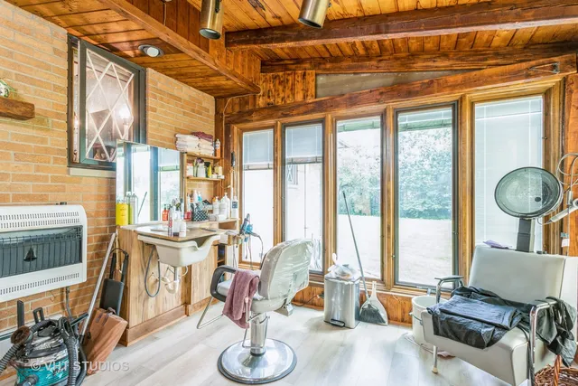 a living room with fireplace furniture and a floor to ceiling window
