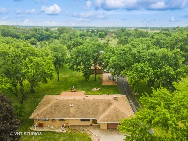 an aerial view of a house with a yard