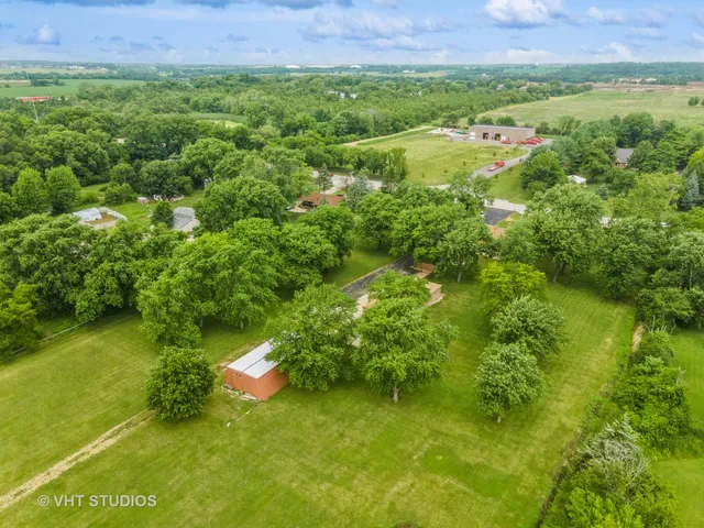 an aerial view of a house with a yard and garden