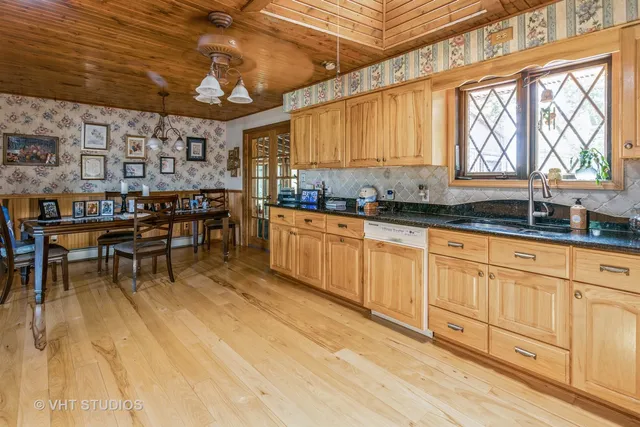 a kitchen with lots of counter top space and dining table