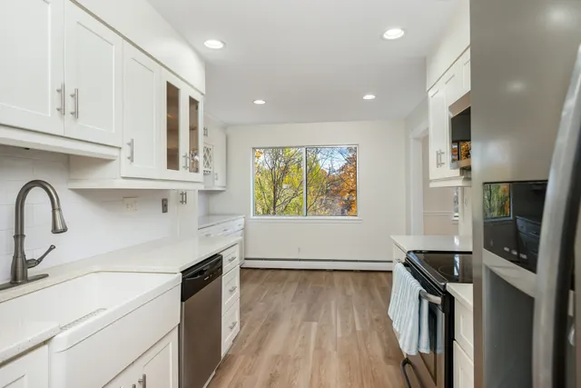 a kitchen with stainless steel appliances a sink stove and cabinets