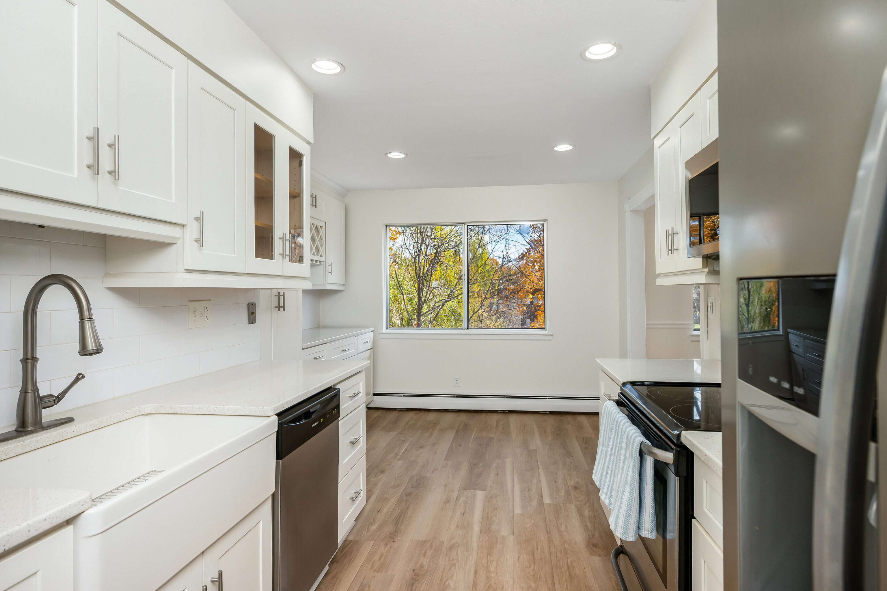 154 Cold Spring Road, Unit 71 Stamford, CT 06905 - Photo 2 of 19 a kitchen with stainless steel appliances a sink stove and cabinets