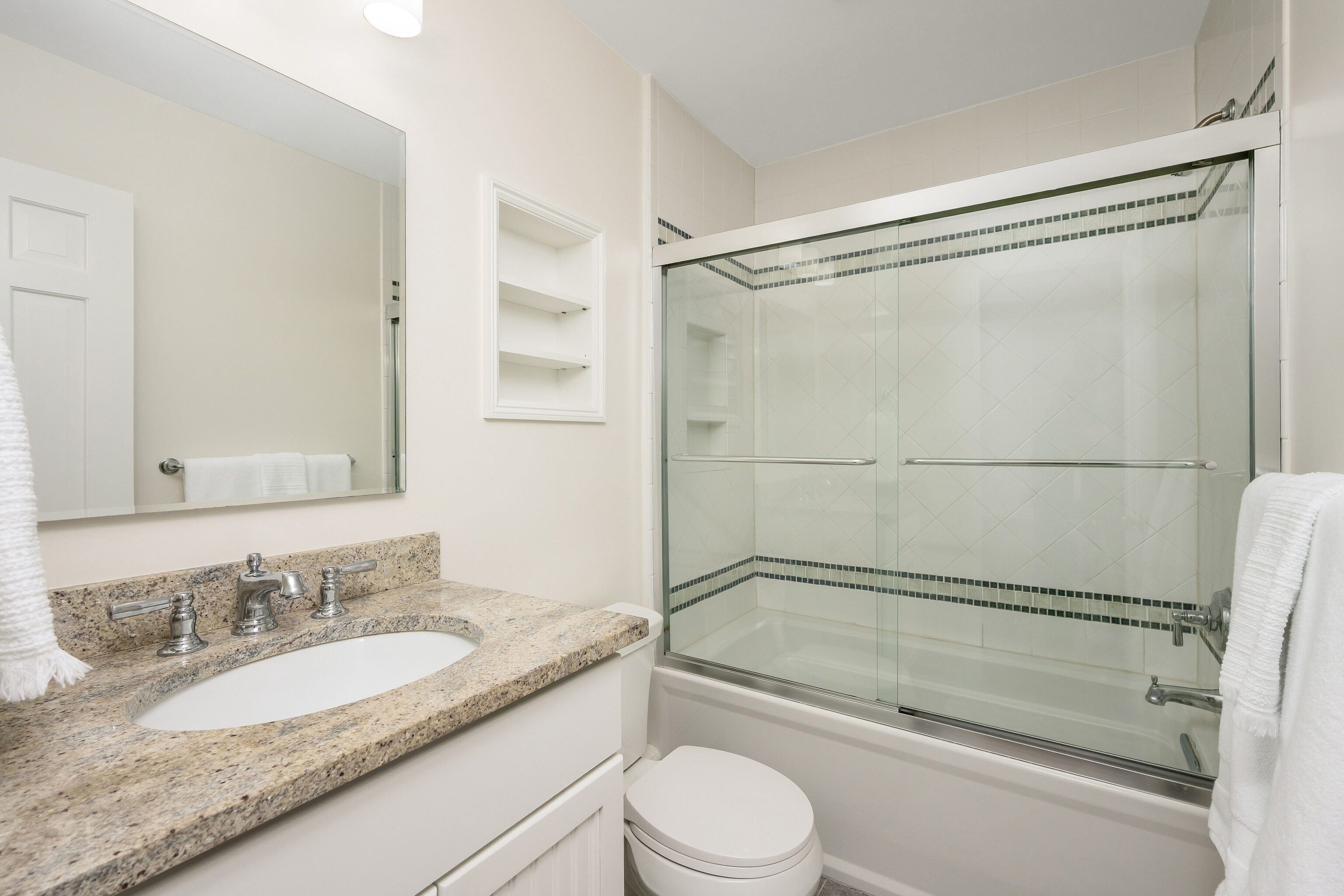 154 Cold Spring Road, Unit 71 Stamford, CT 06905 - Photo 10 of 19 a bathroom with a granite countertop bathtub shower sink vanity and toilet