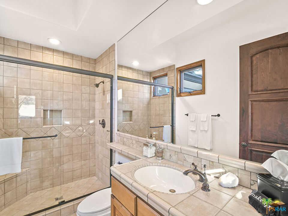 72733 Verbenia Road Rancho Mirage, CA 92270 - Photo 14 of 33 a bathroom with a sink shower and a mirror