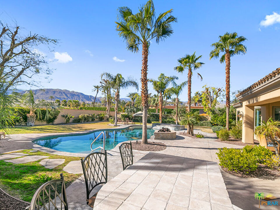 72733 Verbenia Road Rancho Mirage, CA 92270 - Photo 26 of 33 a view of a swimming pool with a table and chairs