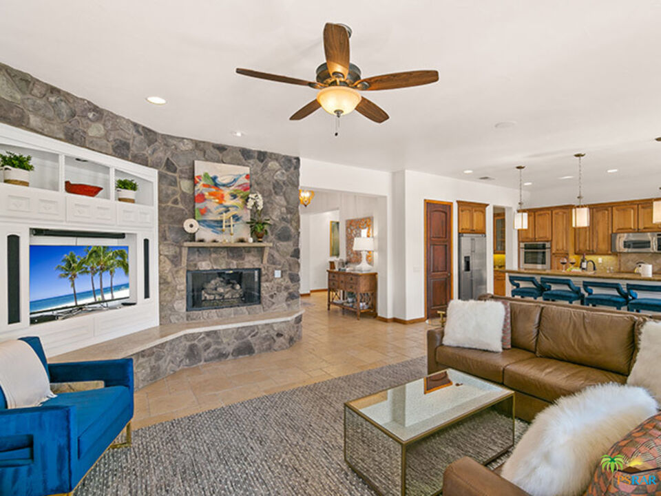 72733 Verbenia Road Rancho Mirage, CA 92270 - Photo 3 of 33 a living room with furniture kitchen view and a fireplace