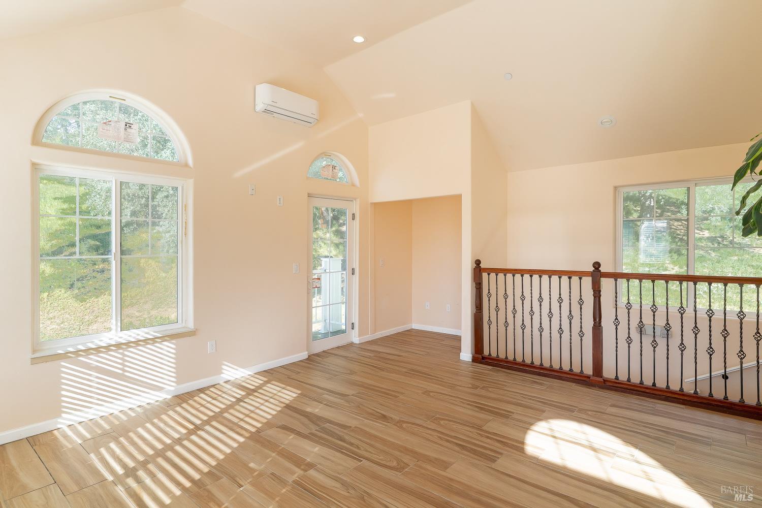 1486 Steele Canyon Road Napa, CA 94558 - Photo 14 of 46 a view of a bedroom with wooden floor fan and windows