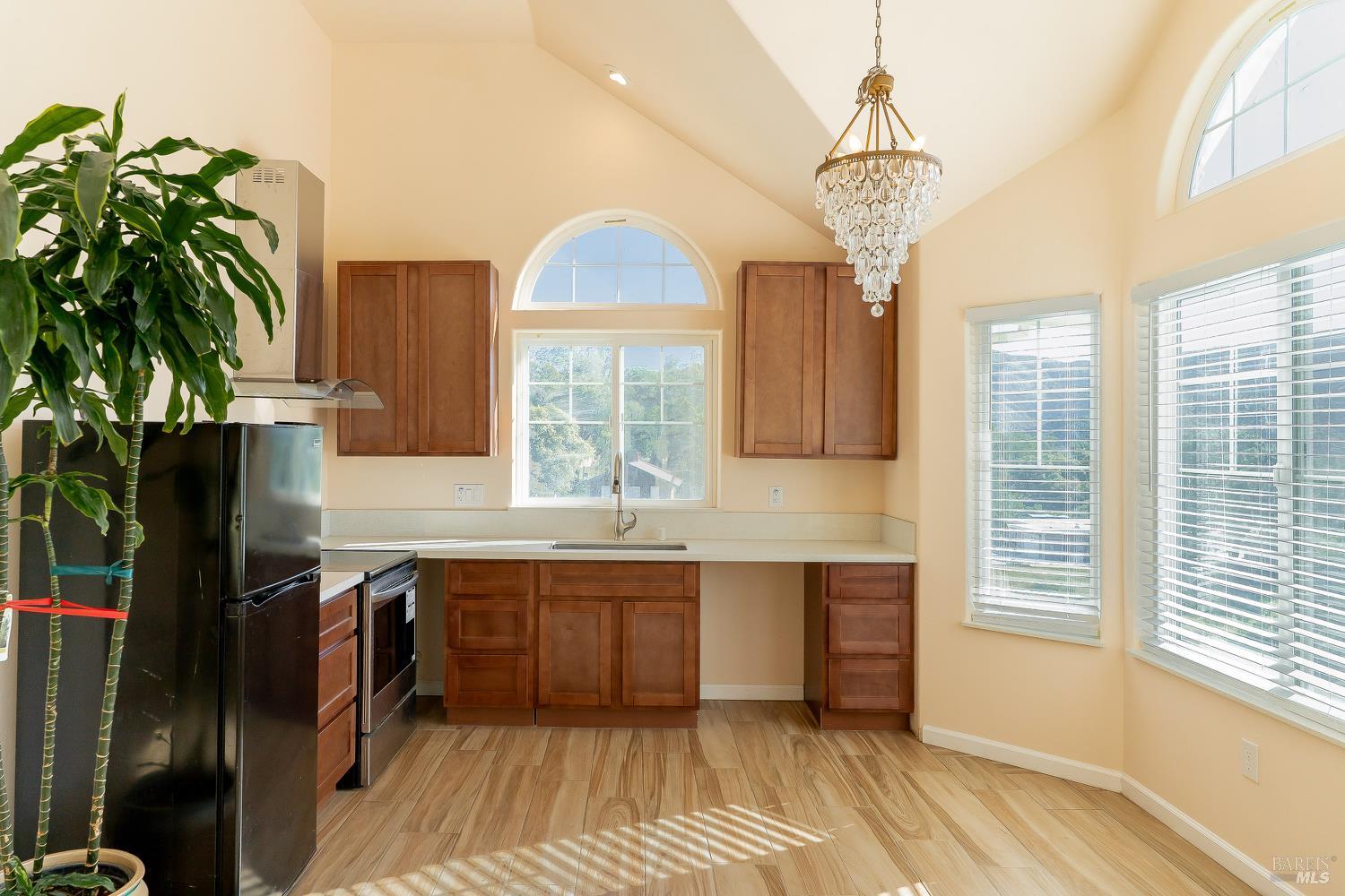 1486 Steele Canyon Road Napa, CA 94558 - Photo 17 of 46 a kitchen with stainless steel appliances a sink stove and cabinets