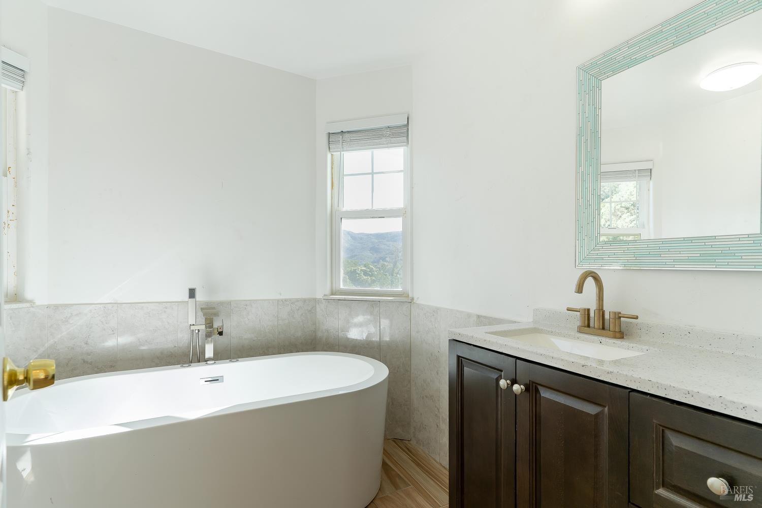 1486 Steele Canyon Road Napa, CA 94558 - Photo 22 of 46 a bathroom with a sink a bathtub and a window