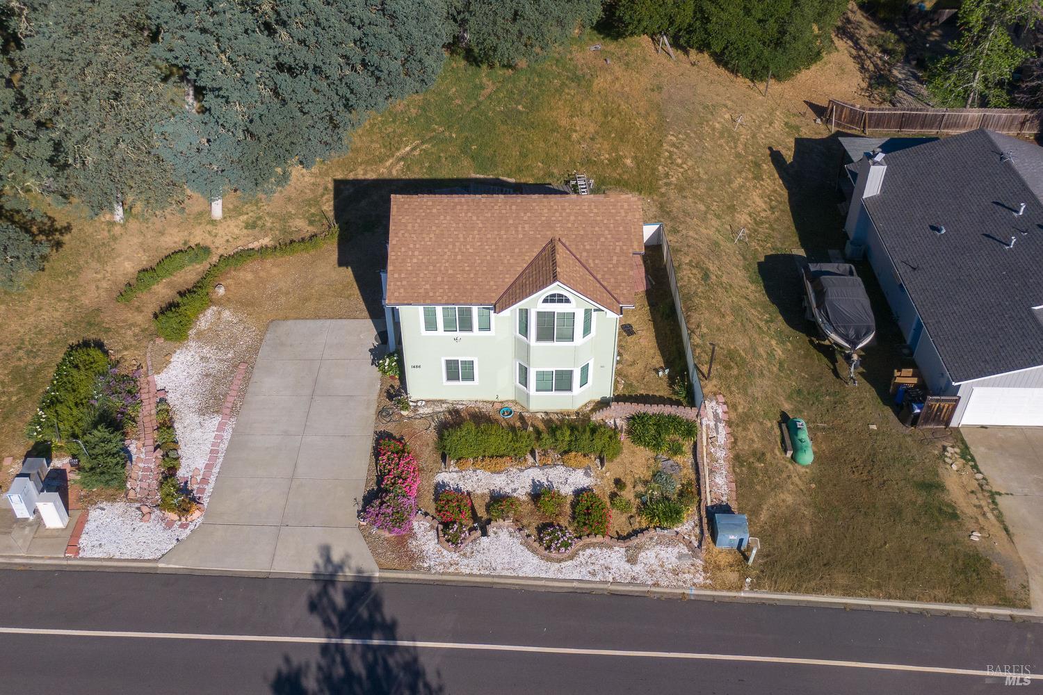 1486 Steele Canyon Road Napa, CA 94558 - Photo 25 of 46 an aerial view of a house with a yard and large tree