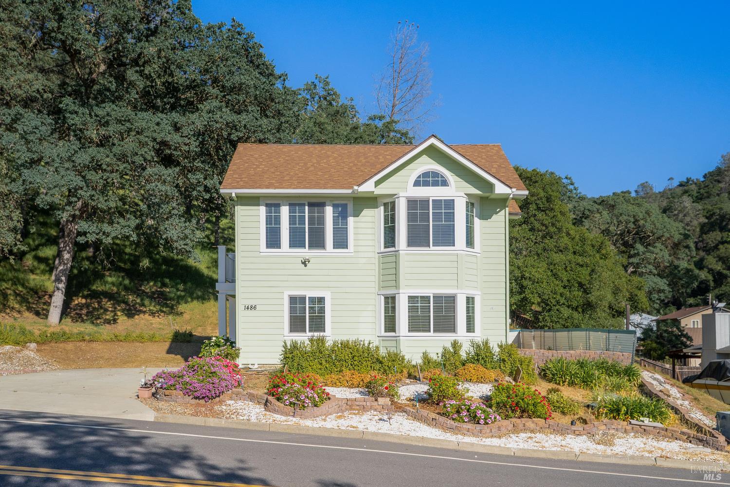 1486 Steele Canyon Road Napa, CA 94558 - Photo 3 of 46 a front view of a house with a yard