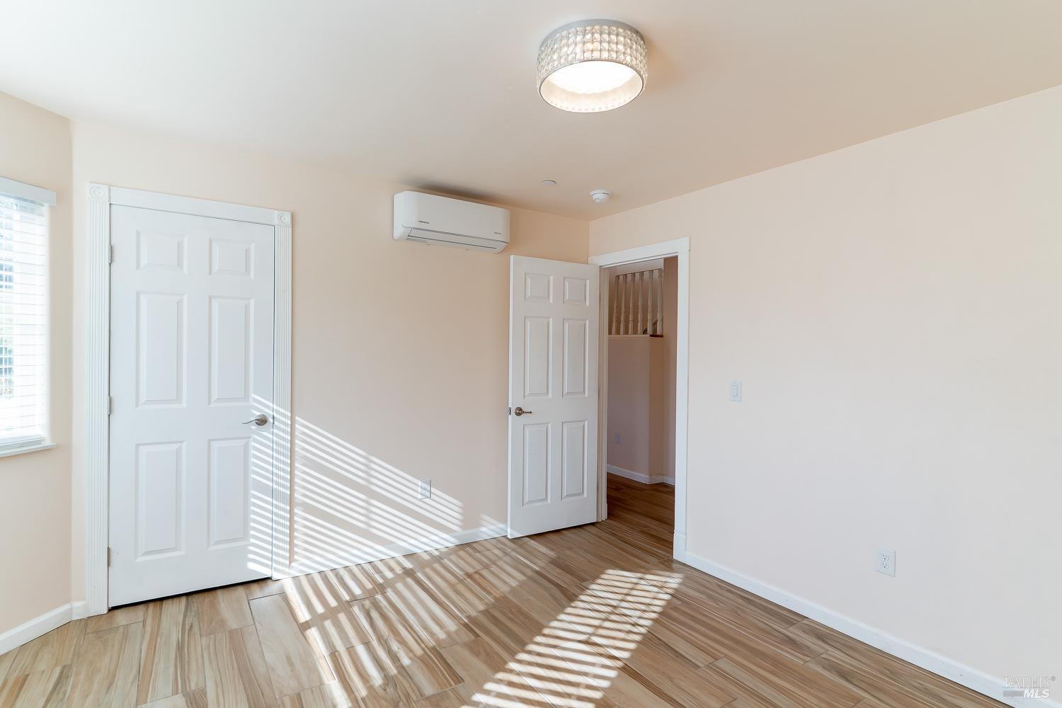 1486 Steele Canyon Road Napa, CA 94558 - Photo 7 of 46 a view of an empty room with wooden floor and a window