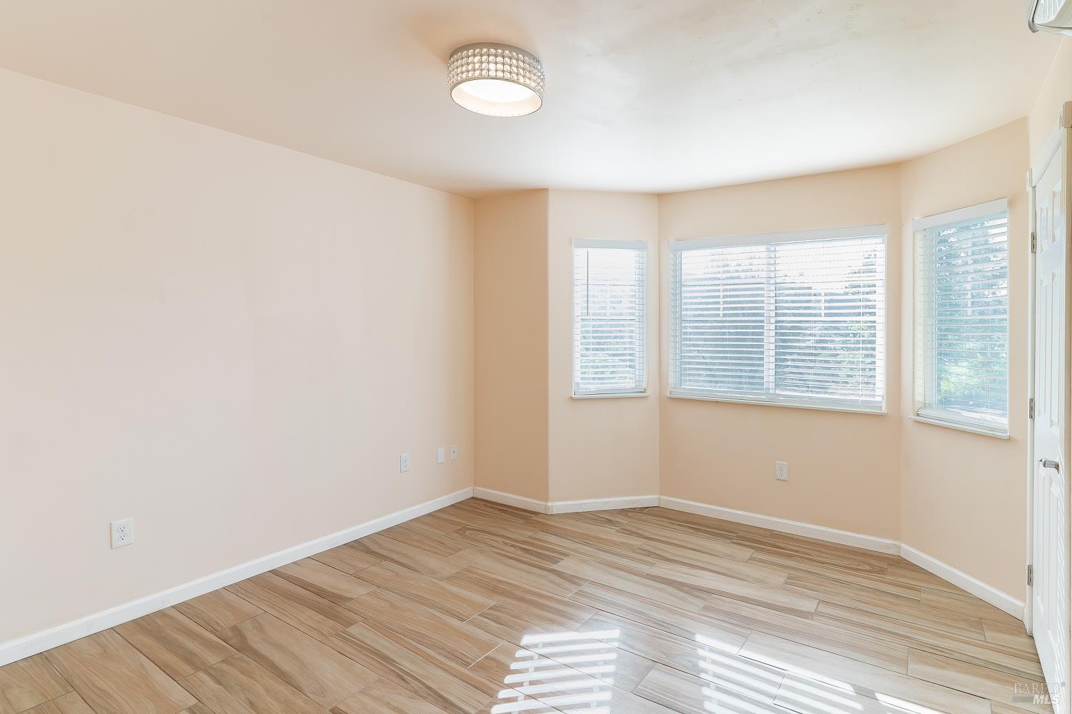 1486 Steele Canyon Road Napa, CA 94558 - Photo 8 of 46 an empty room with wooden floor and windows