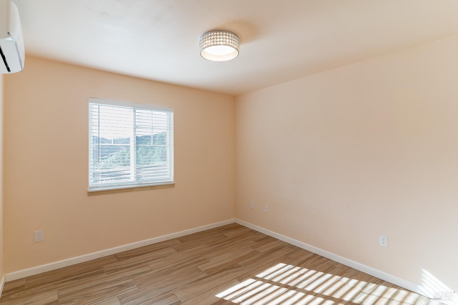 1486 Steele Canyon Road Napa, CA 94558 - Photo 9 of 46 an empty room with wooden floor and windows