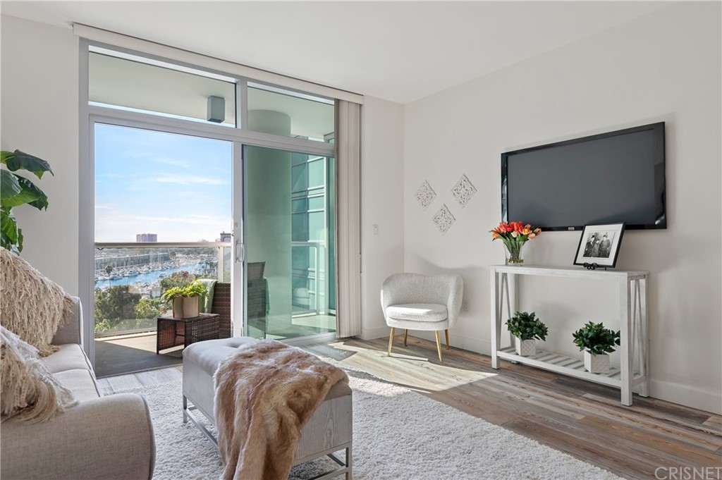 13700 Marina Pointe Drive, Unit 1214 Marina del Rey, CA 90292 - Photo 1 of 1 a living room with furniture and a flat screen tv