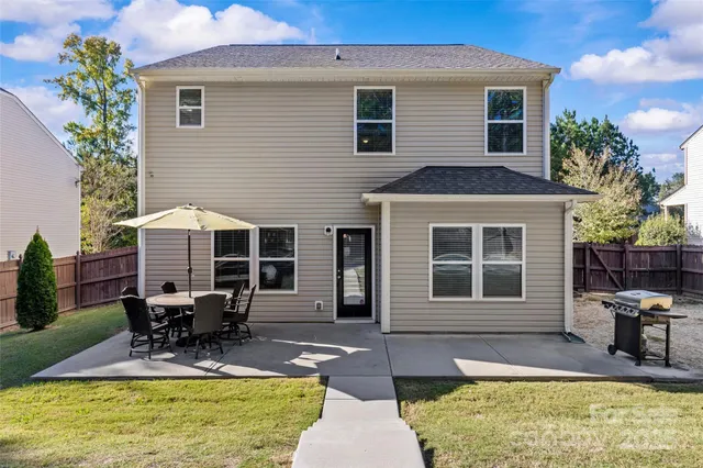 a view of a house with swimming pool and sitting area