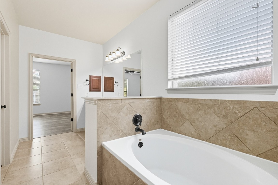 2409 Pauma Valley Way Pflugerville, TX 78660 - Photo 20 of 37 Bathroom featuring a bath and light tile patterned flooring
