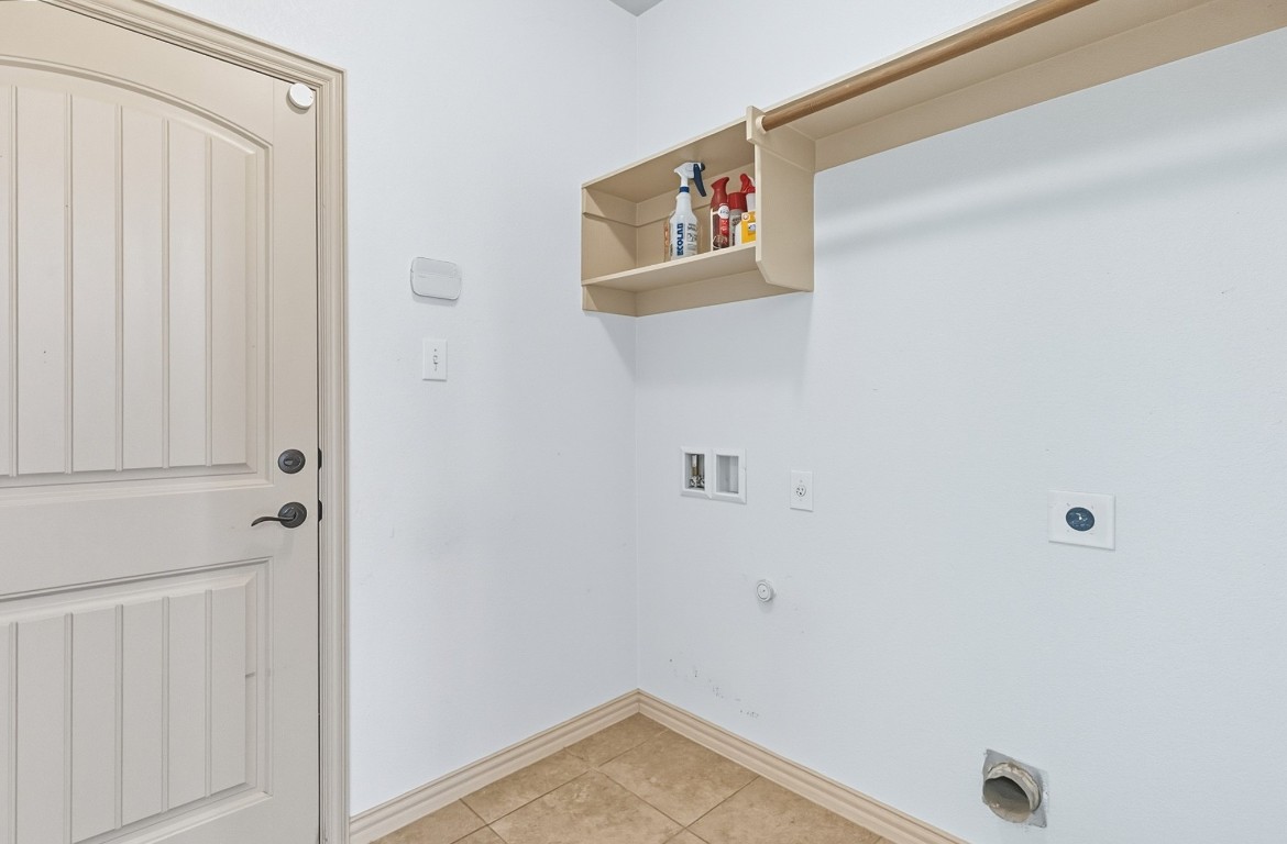 2409 Pauma Valley Way Pflugerville, TX 78660 - Photo 23 of 37 Laundry area featuring gas dryer hookup, light tile patterned flooring, washer hookup, and electric dryer hookup