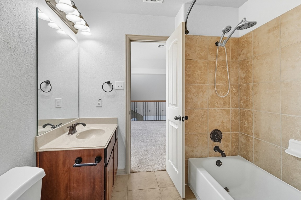2409 Pauma Valley Way Pflugerville, TX 78660 - Photo 24 of 37 Full bath with shower / tub combination, vanity, and light tile patterned floors