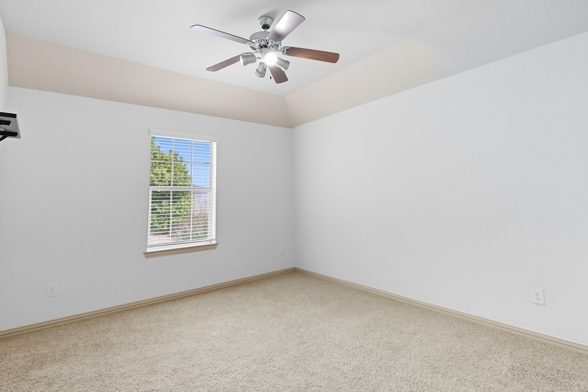 2409 Pauma Valley Way Pflugerville, TX 78660 - Photo 25 of 37 Carpeted empty room featuring baseboards and a ceiling fan