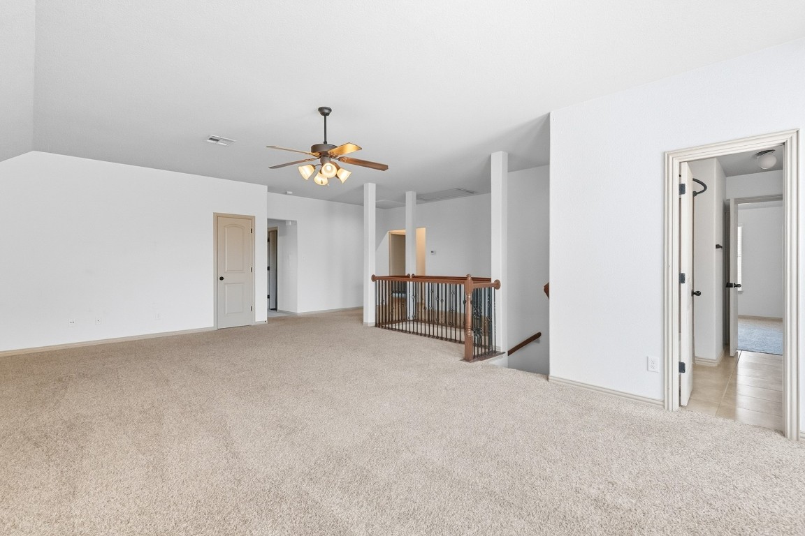 2409 Pauma Valley Way Pflugerville, TX 78660 - Photo 32 of 37 Spare room with light colored carpet and ceiling fan