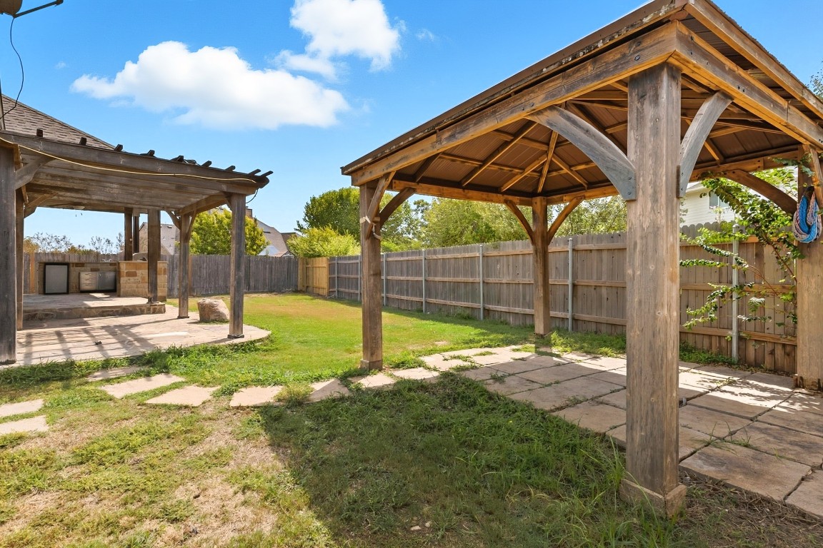 2409 Pauma Valley Way Pflugerville, TX 78660 - Photo 35 of 37 Fenced backyard with a patio