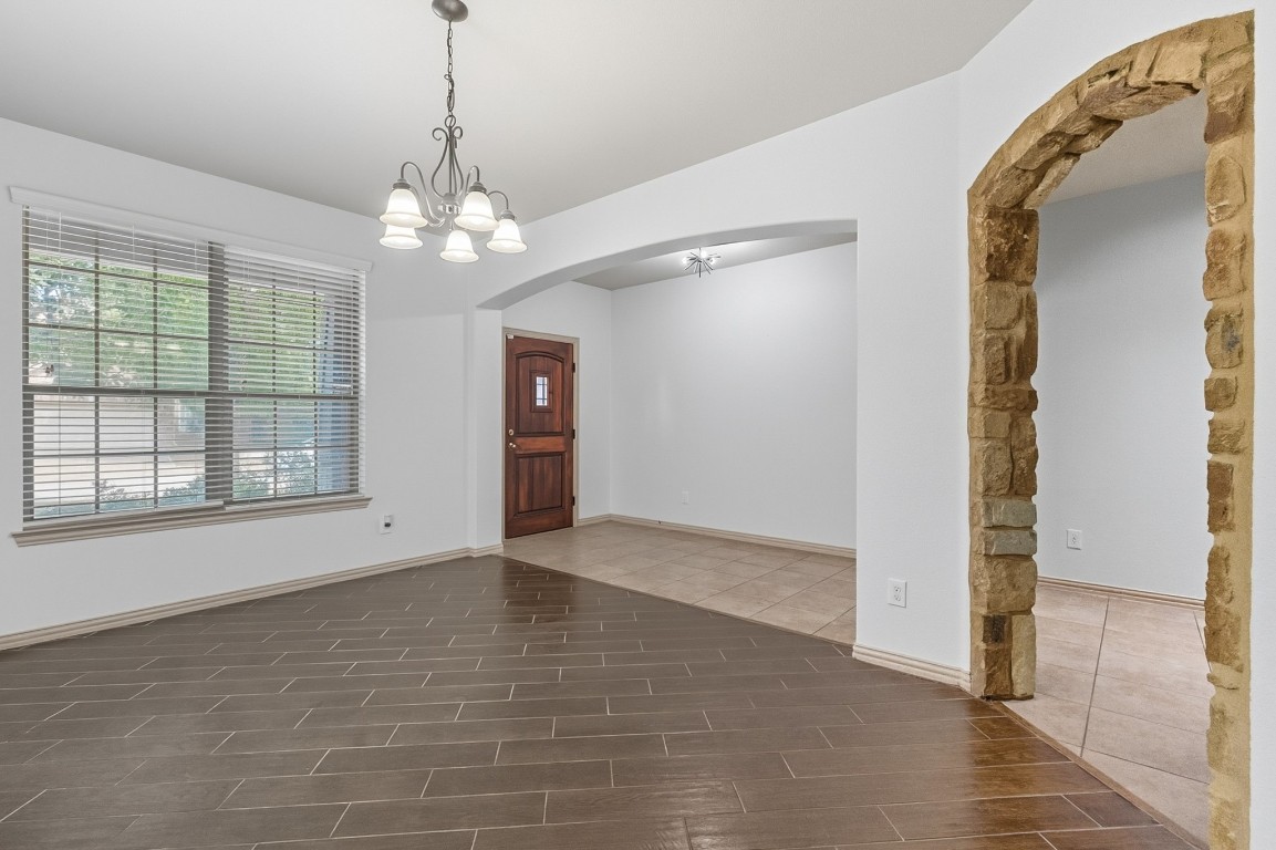 2409 Pauma Valley Way Pflugerville, TX 78660 - Photo 7 of 37 Entryway featuring wood finish floors, a chandelier, and arched walkways
