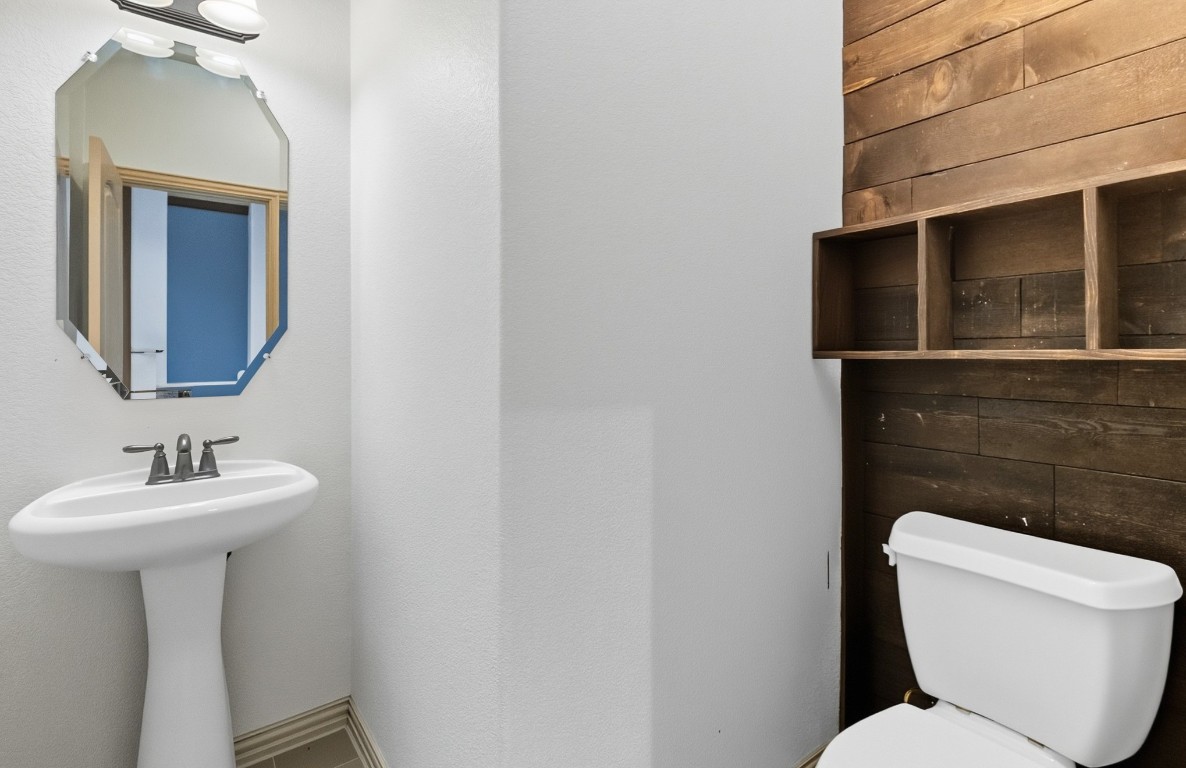 2409 Pauma Valley Way Pflugerville, TX 78660 - Photo 8 of 37 Half bathroom with toilet and wood walls