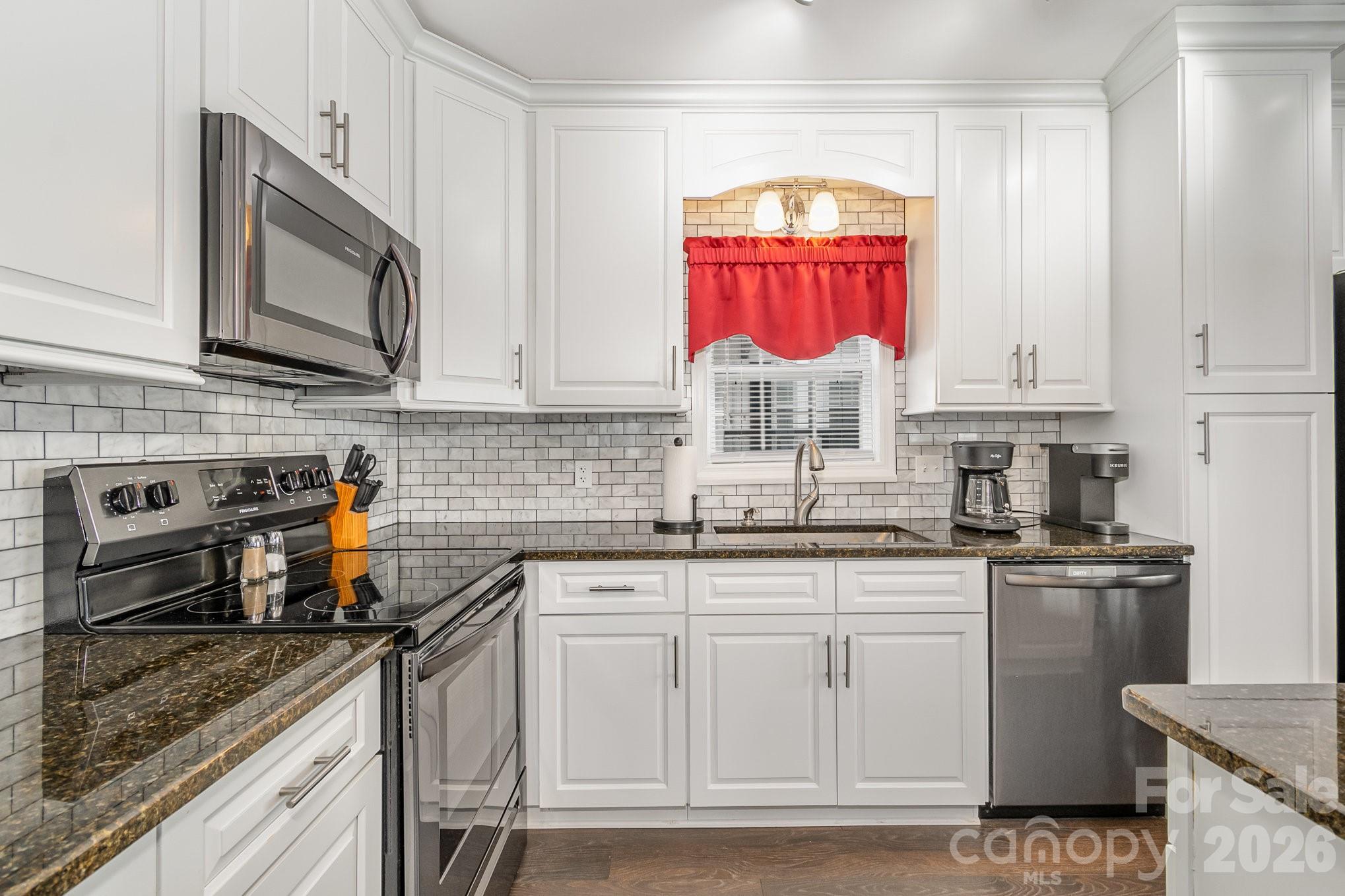 141 Badin Lake Road New London, NC 28127 - Photo 11 of 47 a kitchen with stainless steel appliances granite countertop a stove sink and cabinets