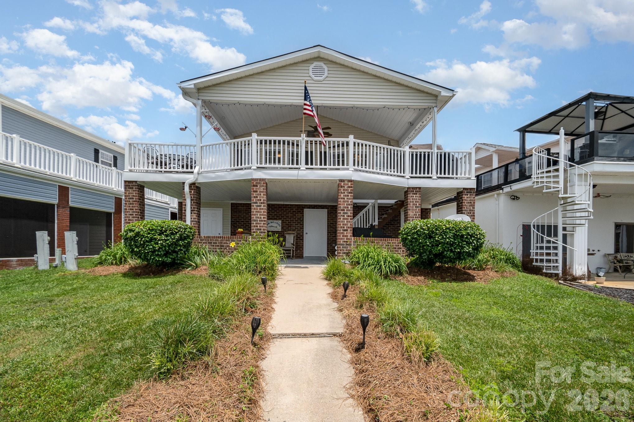 141 Badin Lake Road New London, NC 28127 - Photo 19 of 47 a front view of a house with a yard and potted plants