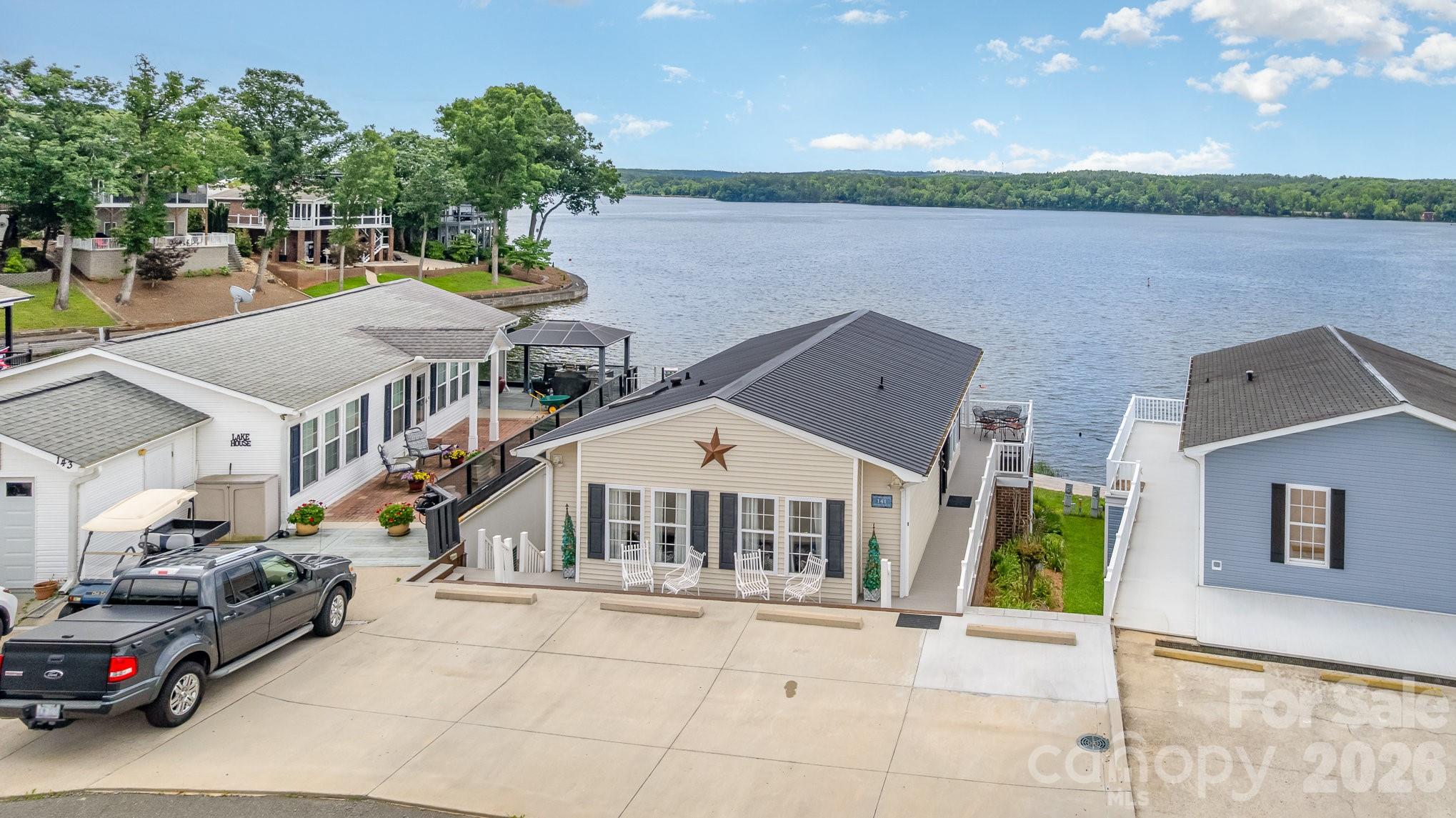 141 Badin Lake Road New London, NC 28127 - Photo 2 of 47 a aerial view of a house with garden