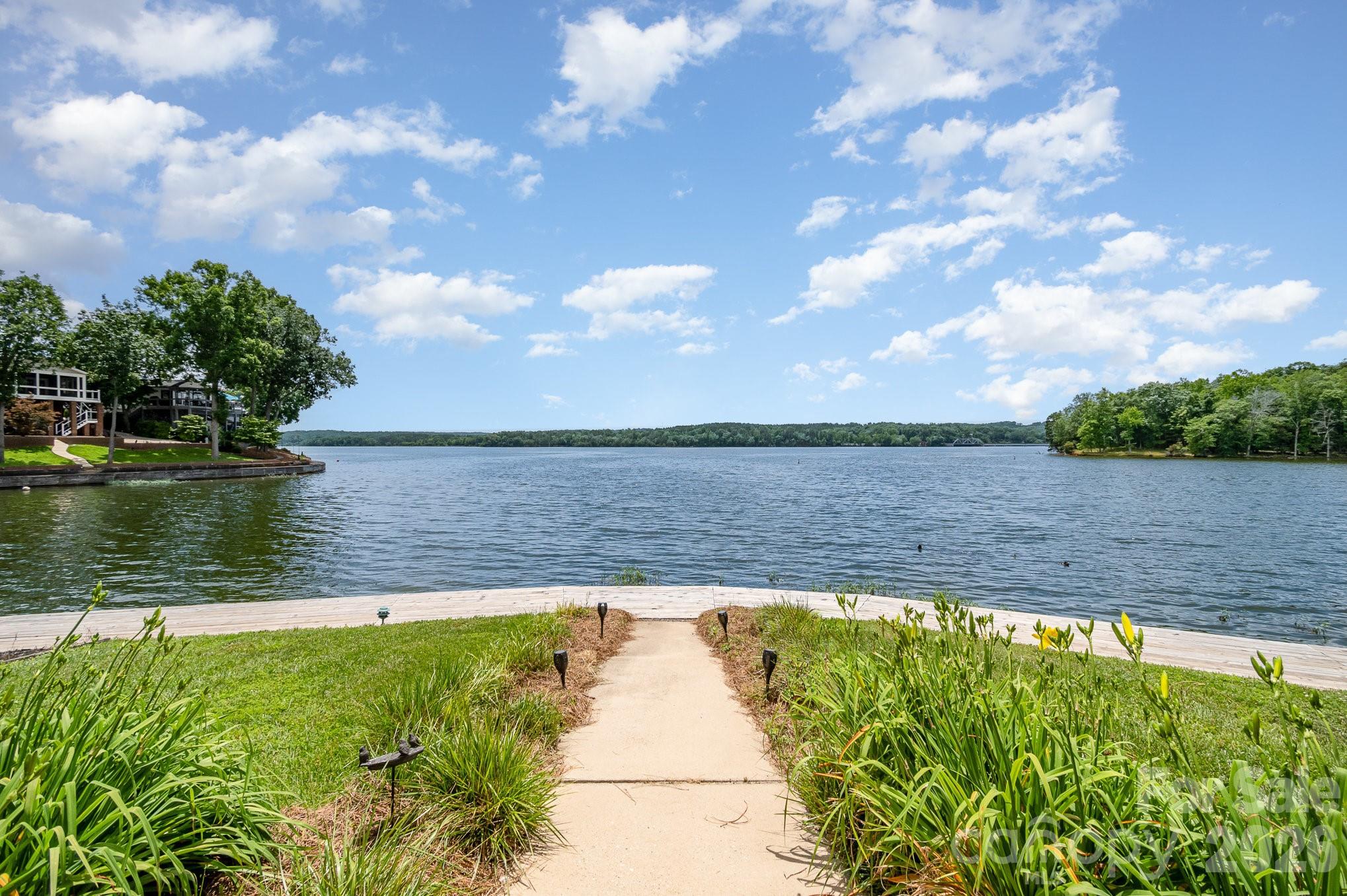 141 Badin Lake Road New London, NC 28127 - Photo 24 of 47 a view of a lake with a big yard