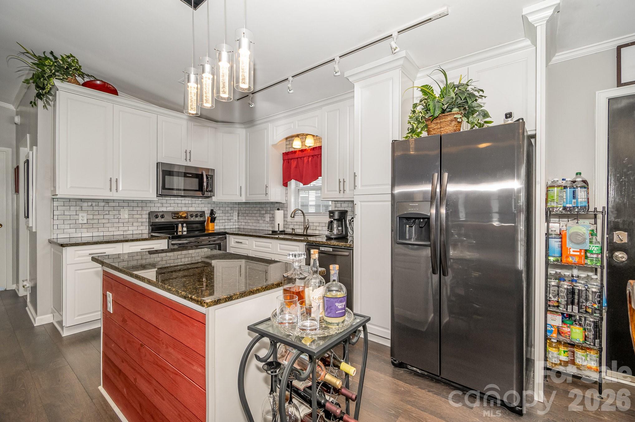 141 Badin Lake Road New London, NC 28127 - Photo 10 of 47 a kitchen with stainless steel appliances granite countertop a refrigerator and a sink