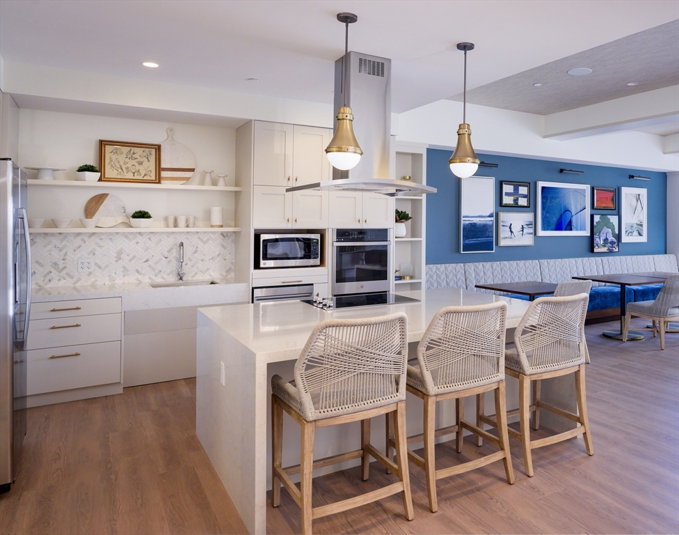 130 Chief Justice Cushing Highway, Unit 213 Scituate, MA 02066 - Photo 19 of 40 a view of kitchen with cabinets and wooden floor