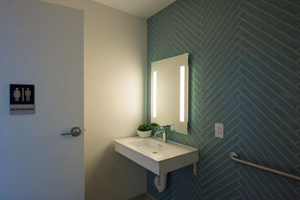 130 Chief Justice Cushing Highway, Unit 213 Scituate, MA 02066 - Photo 20 of 40 a bathroom with a sink toilet and mirror