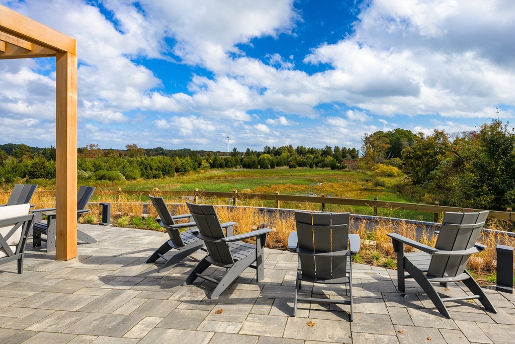 130 Chief Justice Cushing Highway, Unit 213 Scituate, MA 02066 - Photo 25 of 40 a view of a terrace with sitting area