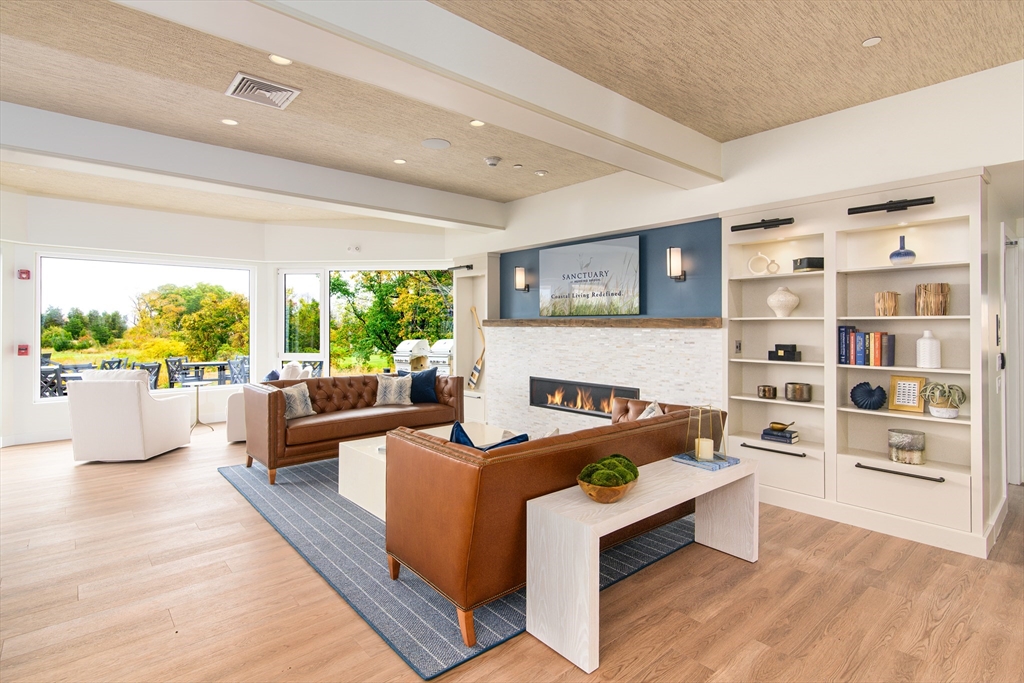 130 Chief Justice Cushing Highway, Unit 213 Scituate, MA 02066 - Photo 8 of 40 a living room with furniture rug and window