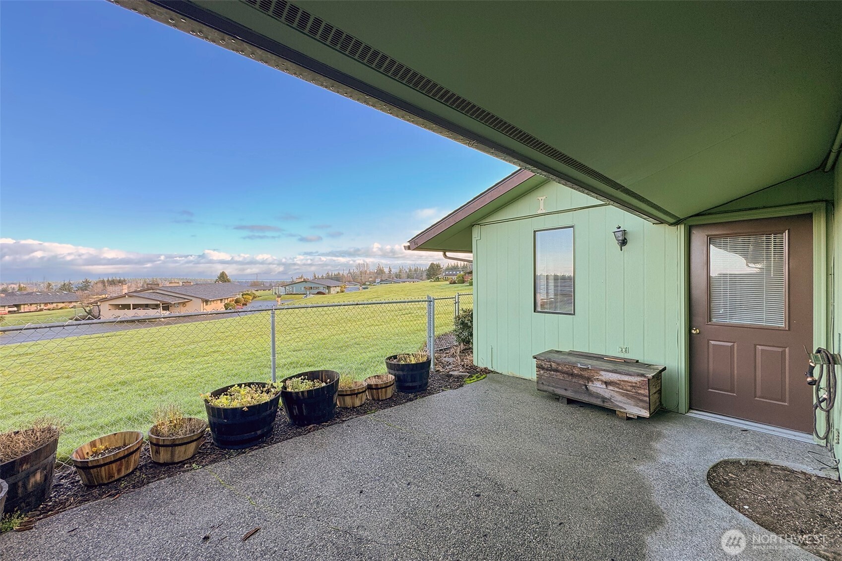 1301 South 3rd Avenue, Unit 9B Sequim, WA 98382 - Photo 14 of 39 a view of a patio with lawn chairs next to a yard