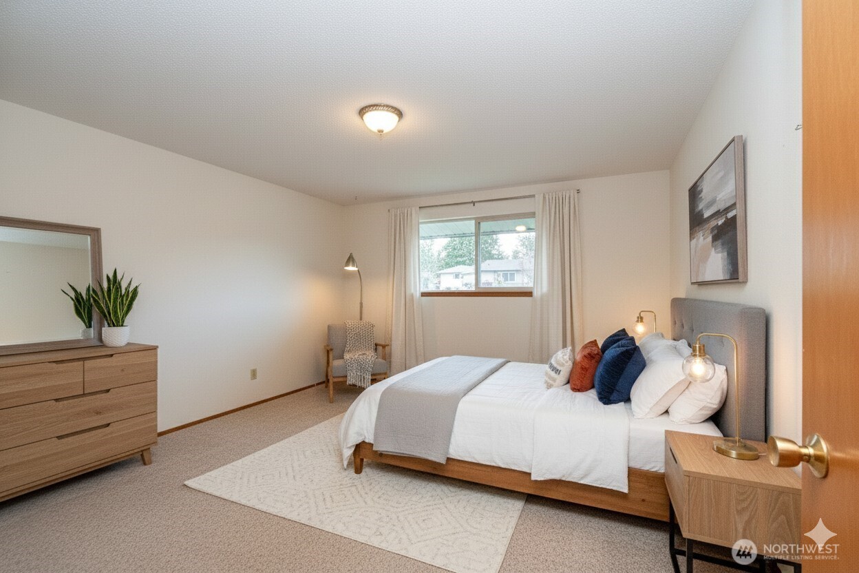 1301 South 3rd Avenue, Unit 9B Sequim, WA 98382 - Photo 17 of 39 a bedroom with a bed and window