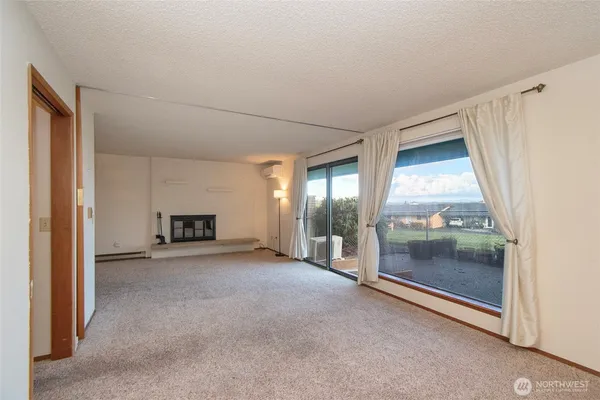 a view of a room with an empty room and fireplace