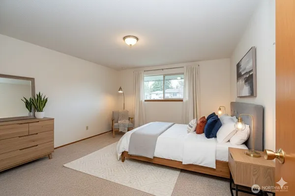 a bedroom with a bed and window