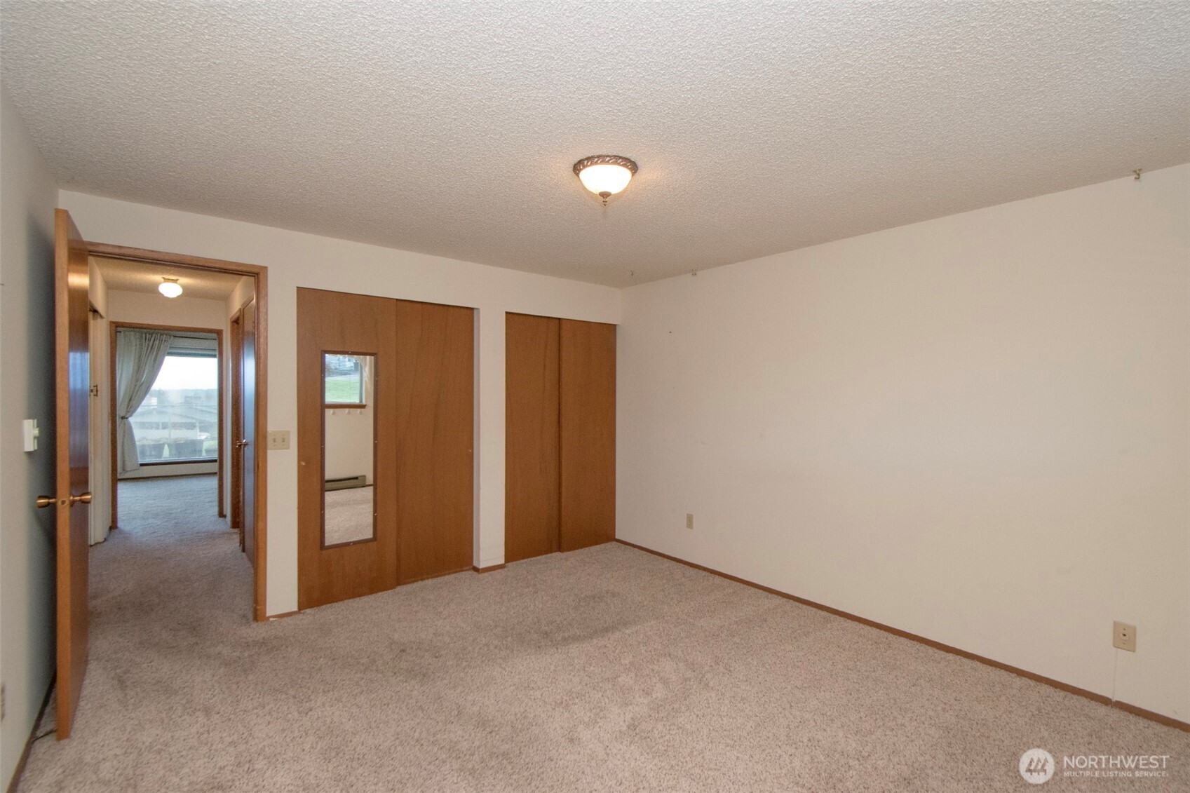 1301 South 3rd Avenue, Unit 9B Sequim, WA 98382 - Photo 20 of 39 an empty room with closet area