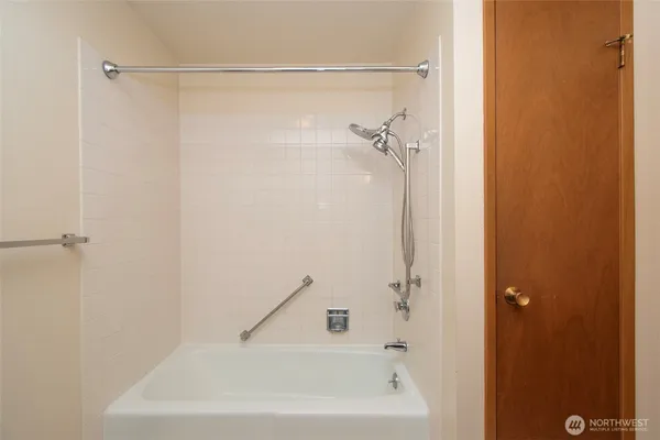 a bathroom with a shower and a bath tub