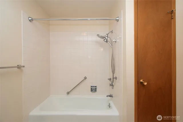 a bathroom with a shower and a bath tub