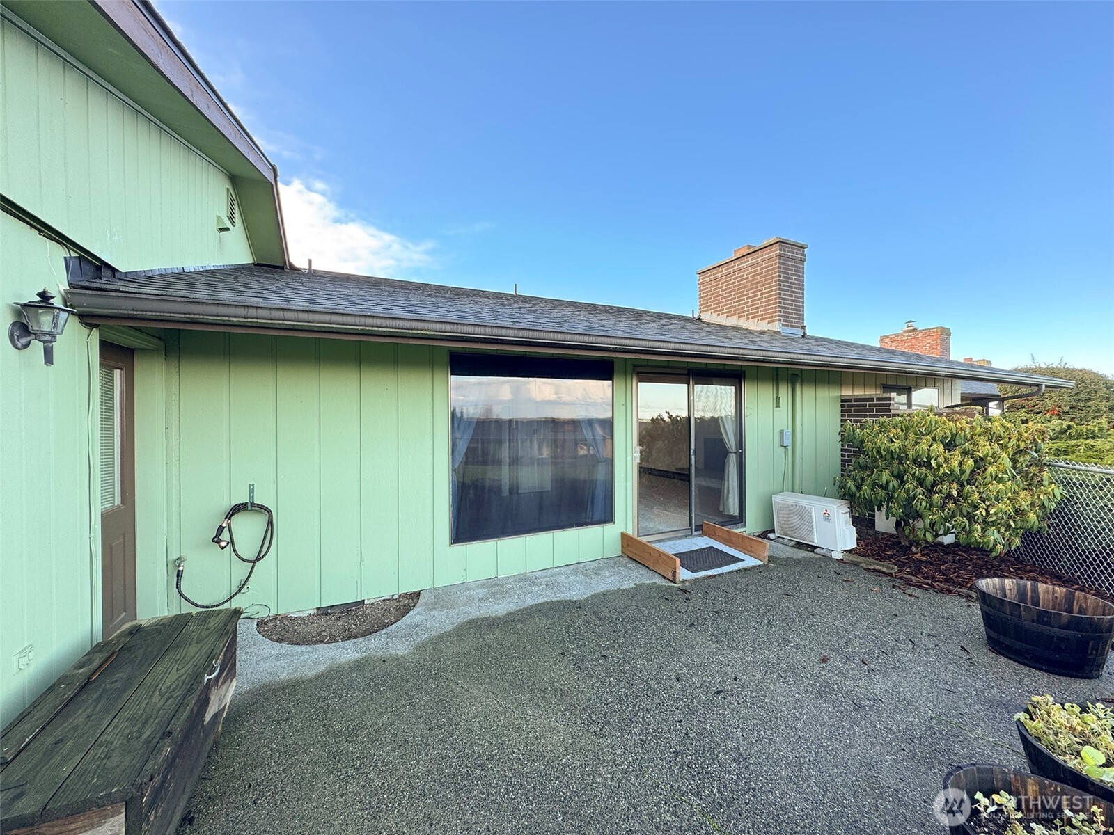1301 South 3rd Avenue, Unit 9B Sequim, WA 98382 - Photo 27 of 39 a view of a backyard with hardwood area and porch