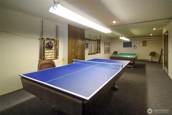 a room with pool table and windows
