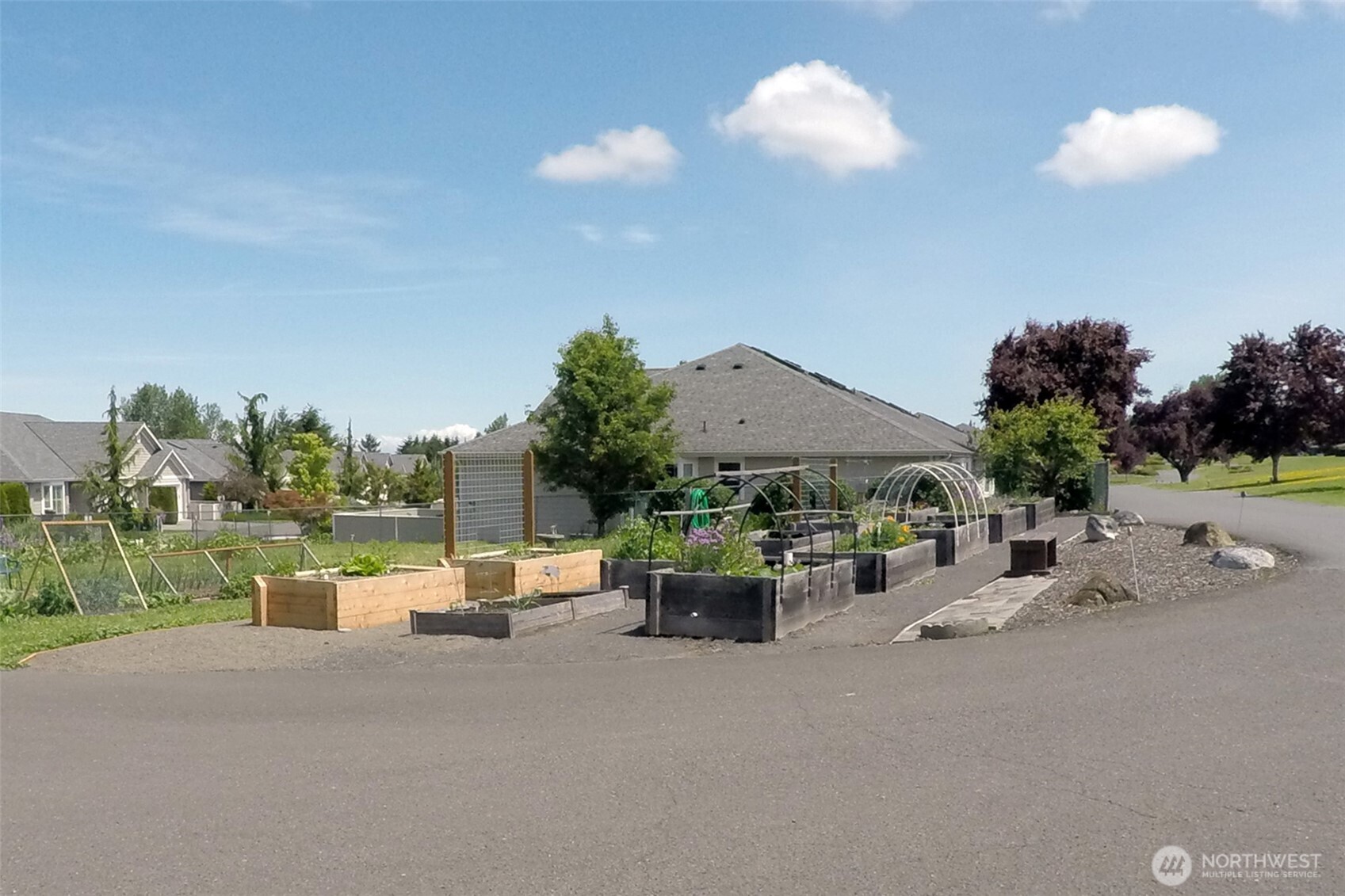 1301 South 3rd Avenue, Unit 9B Sequim, WA 98382 - Photo 38 of 39 a view of a patio with a table and chairs under an umbrella